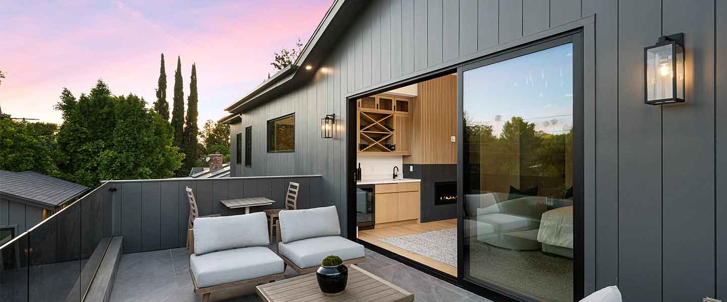 Rooftop terrace with seating beside a glazed wall