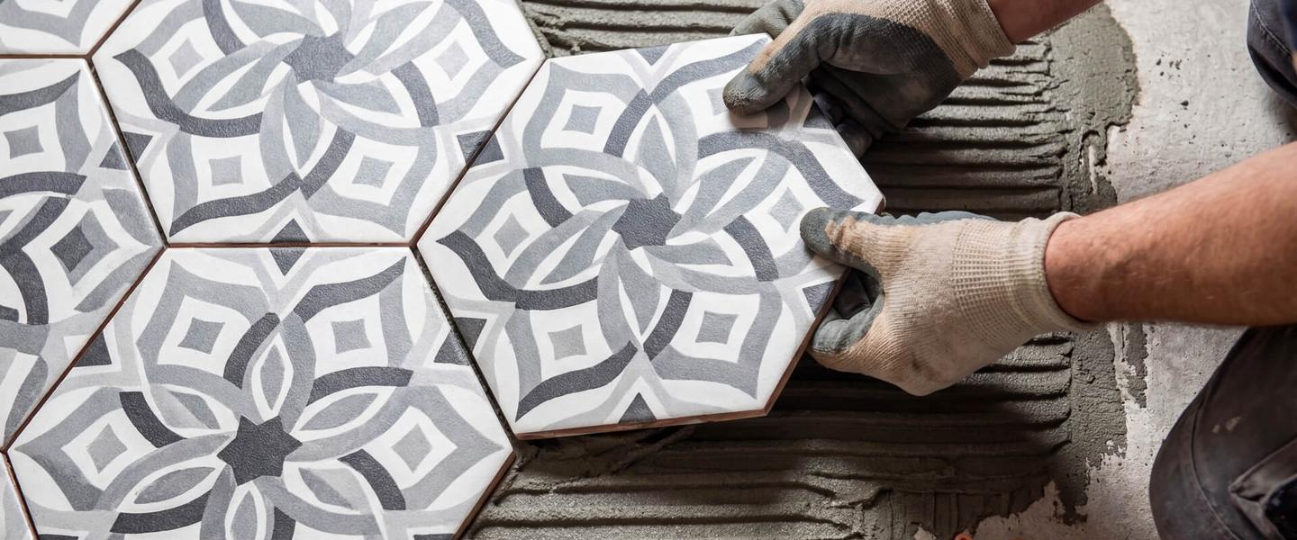 Installer setting patterned hexagonal floor tile